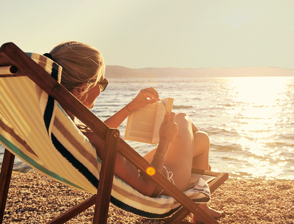 woman reaching on beach during golden hour