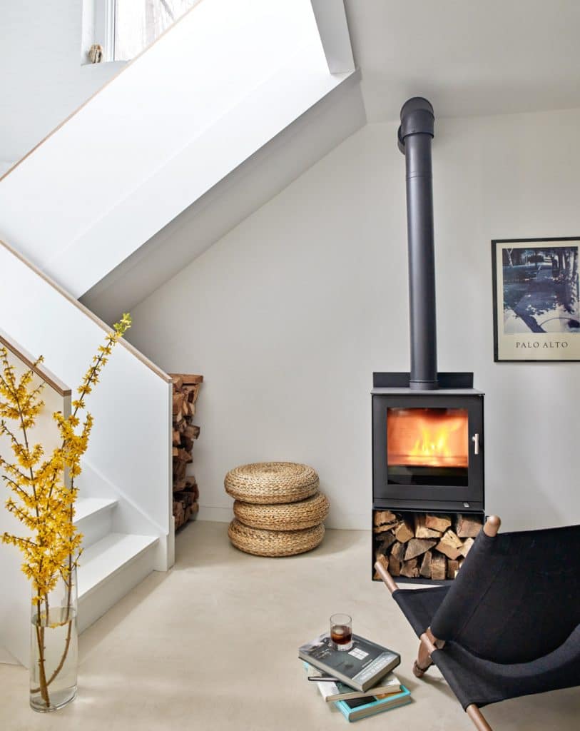 wood burning stove with white staircase