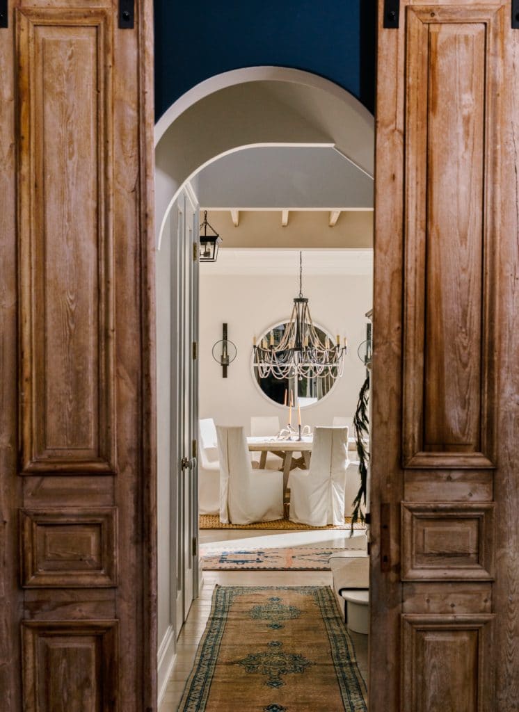 reclaimed old wooden shutters open to dining room