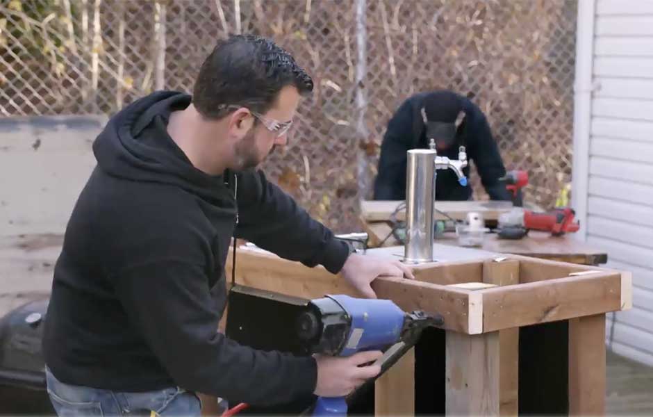 man building a DIY outdoor bar
