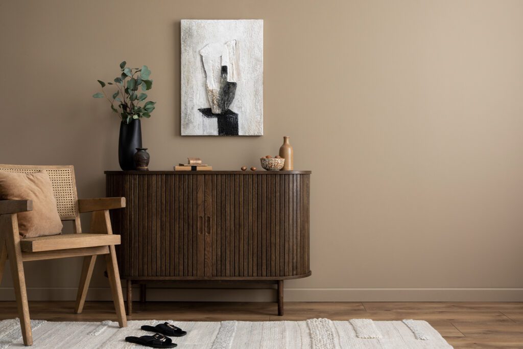 living room accent cabinet with chair and art