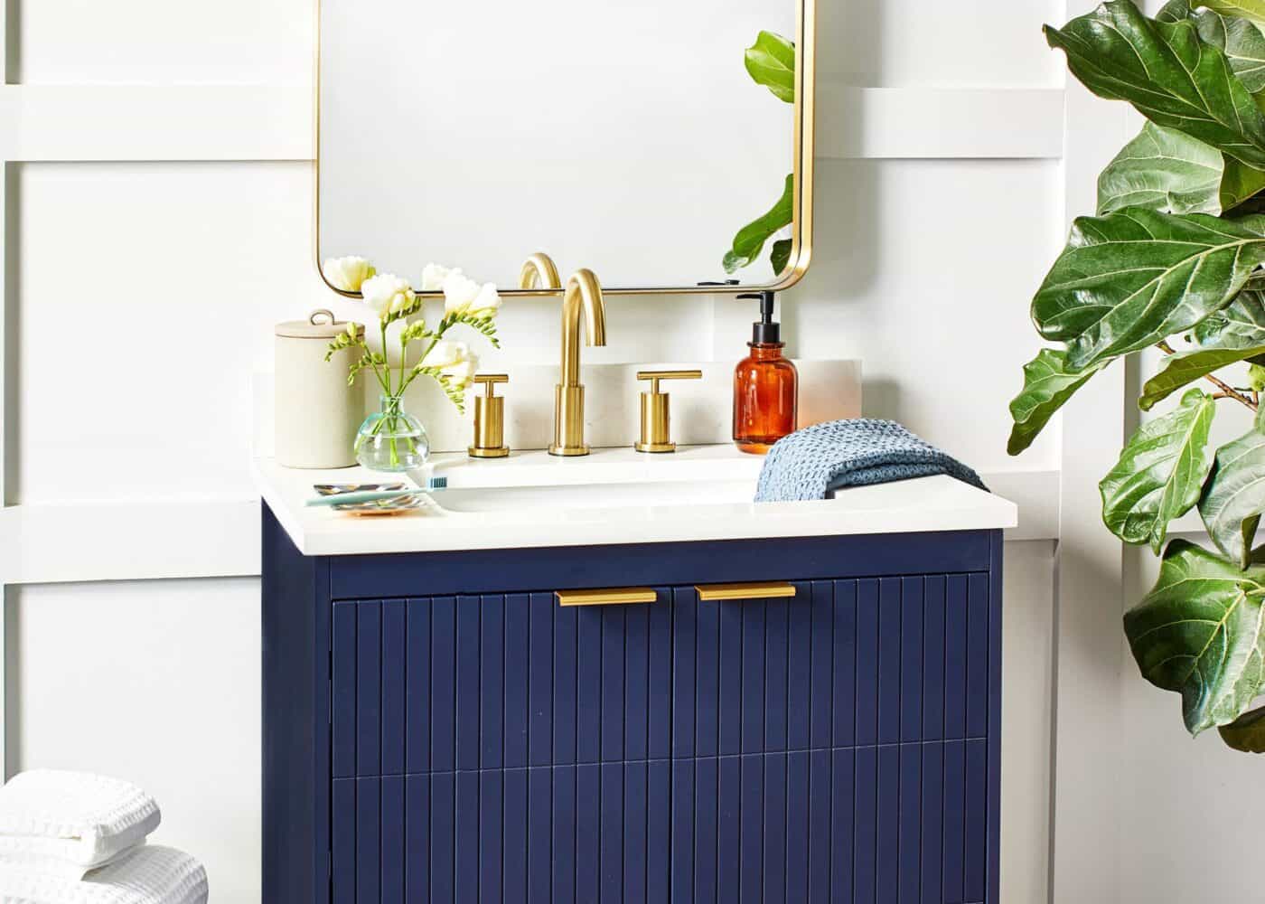 Navy blue bathroom vanity with gold hardware