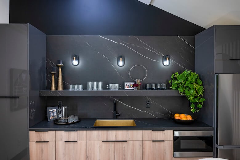 Black kitchen with light wood cabinets