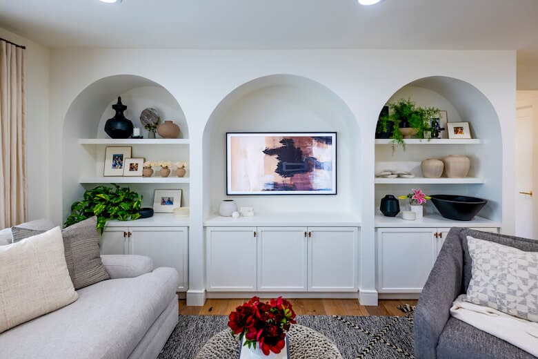 Living room with artwork and decor in arched nooks