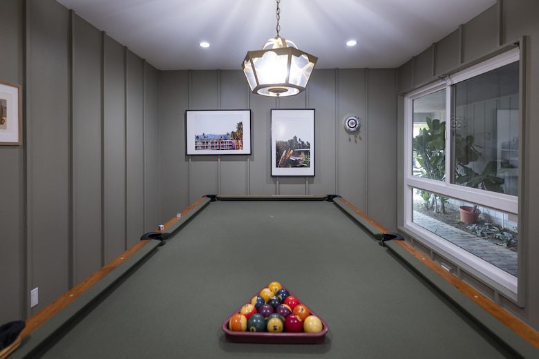 Pool table in game room of jericka and matthew's remodeled Forever Home
