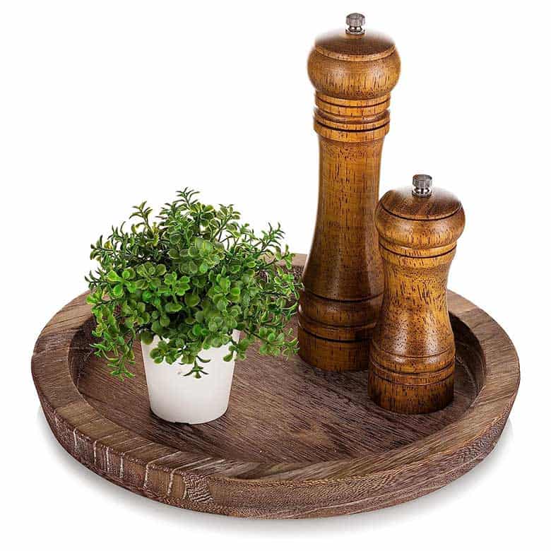 Wooden lazy Susan with a small potted plant and two wooden salt and pepper grinders