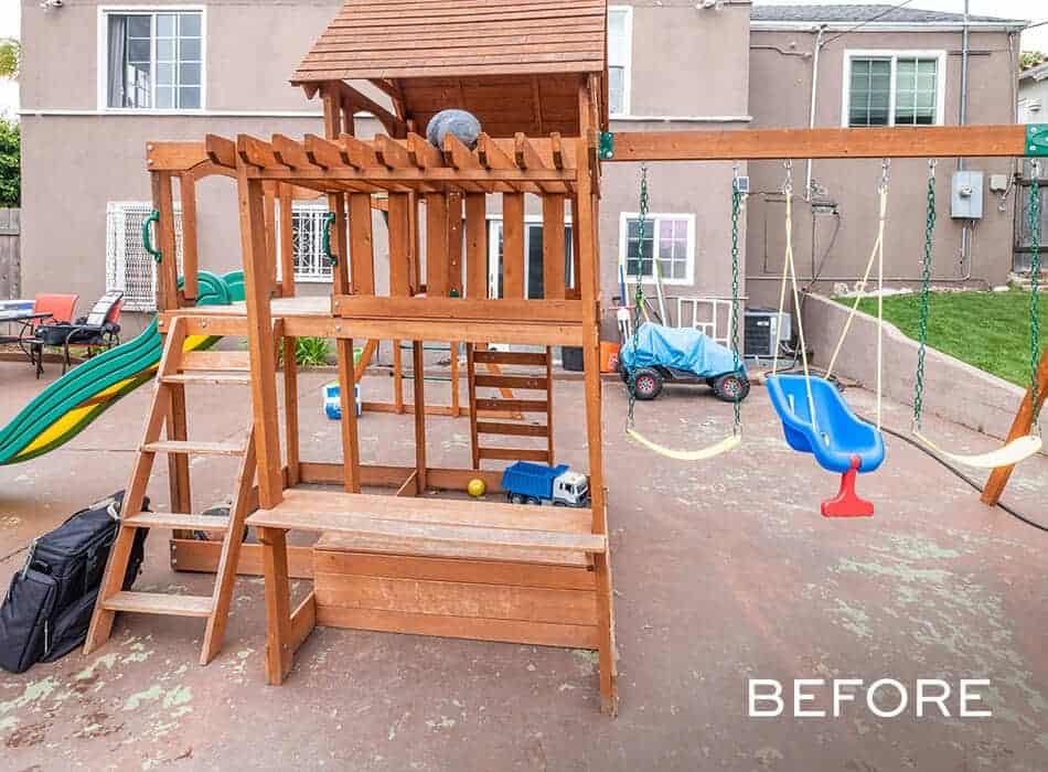 A before image of a wooden backyard playset with swings, a slide, and a bench, situated on a concrete patio