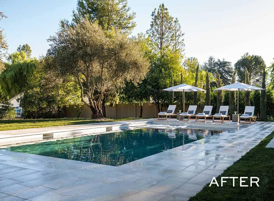 An after image of a luxurious backyard with a rectangular swimming pool surrounded by lounge chairs and umbrellas