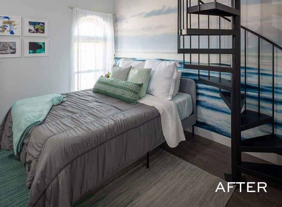Cozy bedroom with ocean wave accent wall gray bedding and black spiral staircase