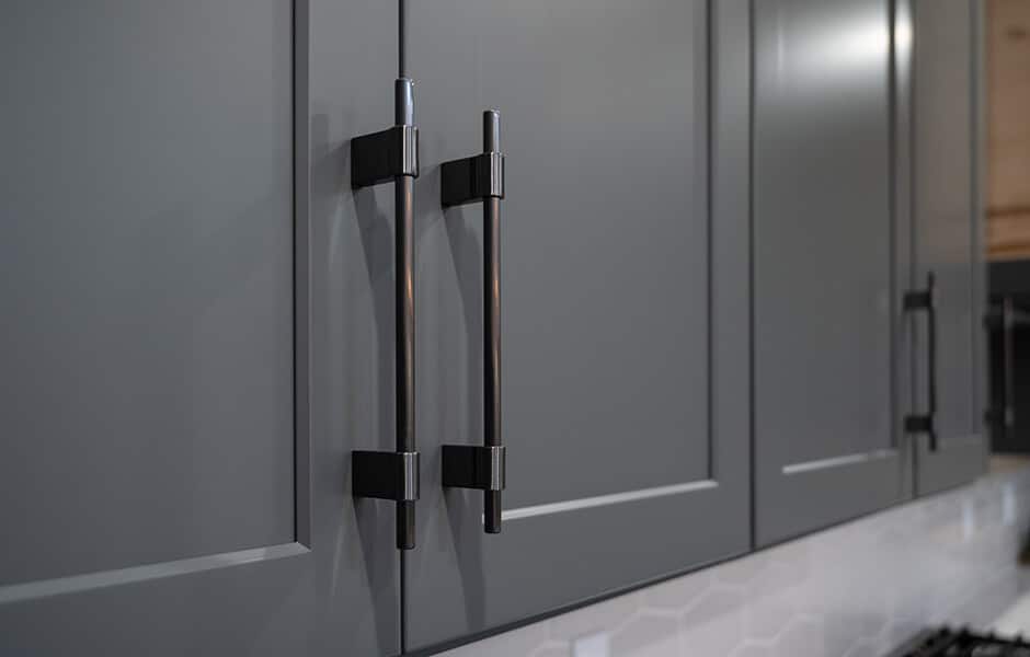 Dark gray kitchen cabinets with modern black metal handles