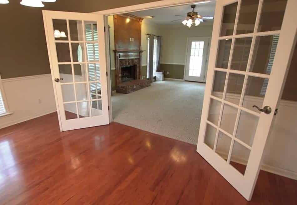 Dining room with a set of double French doors leading to a living room