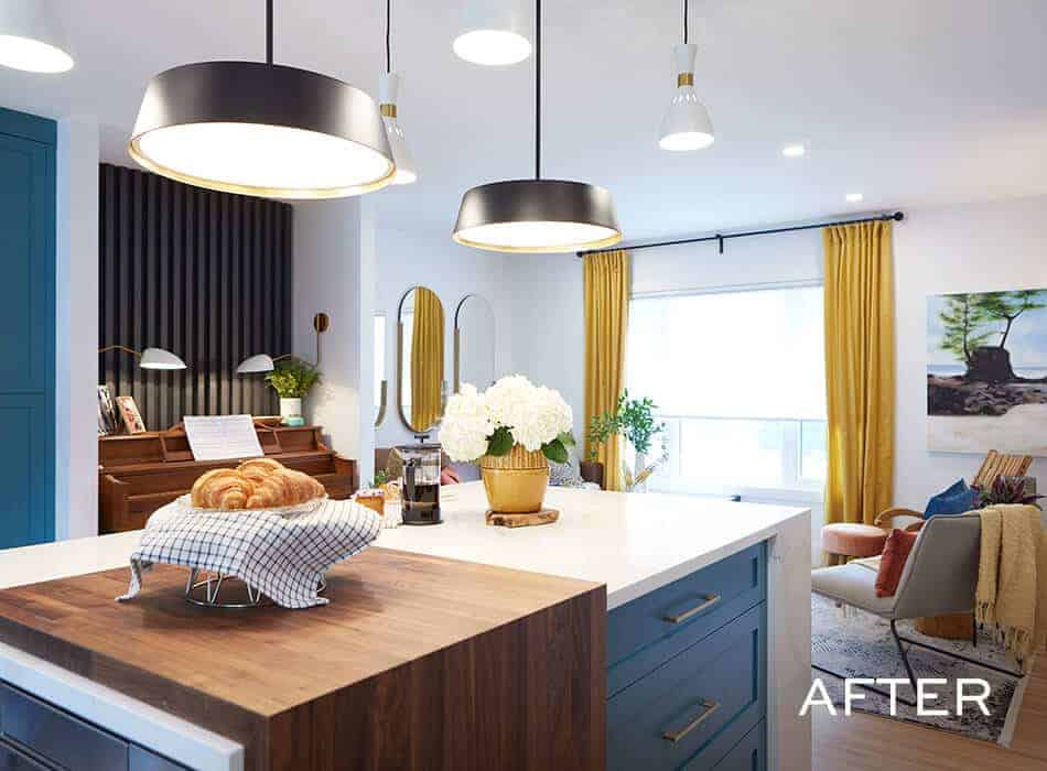 Modern kitchen with a blue island, pendant lights, wood accents, and a cozy seating area with yellow curtains
