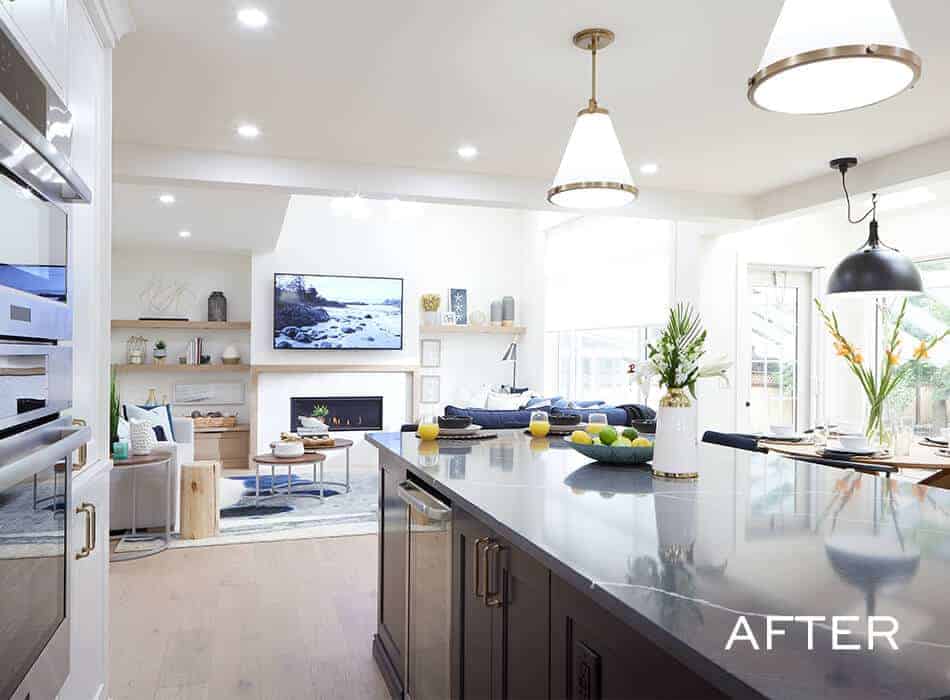 Renovated kitchen interior with modern appliances and seating area.
