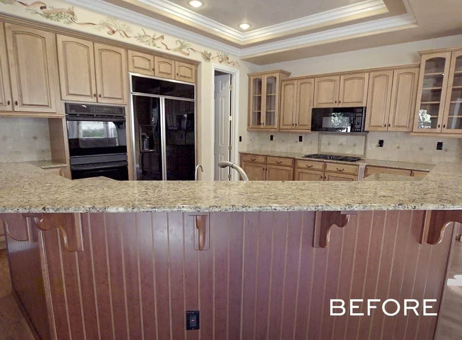 Traditional kitchen with wooden cabinets, granite countertops, and a raised bar area