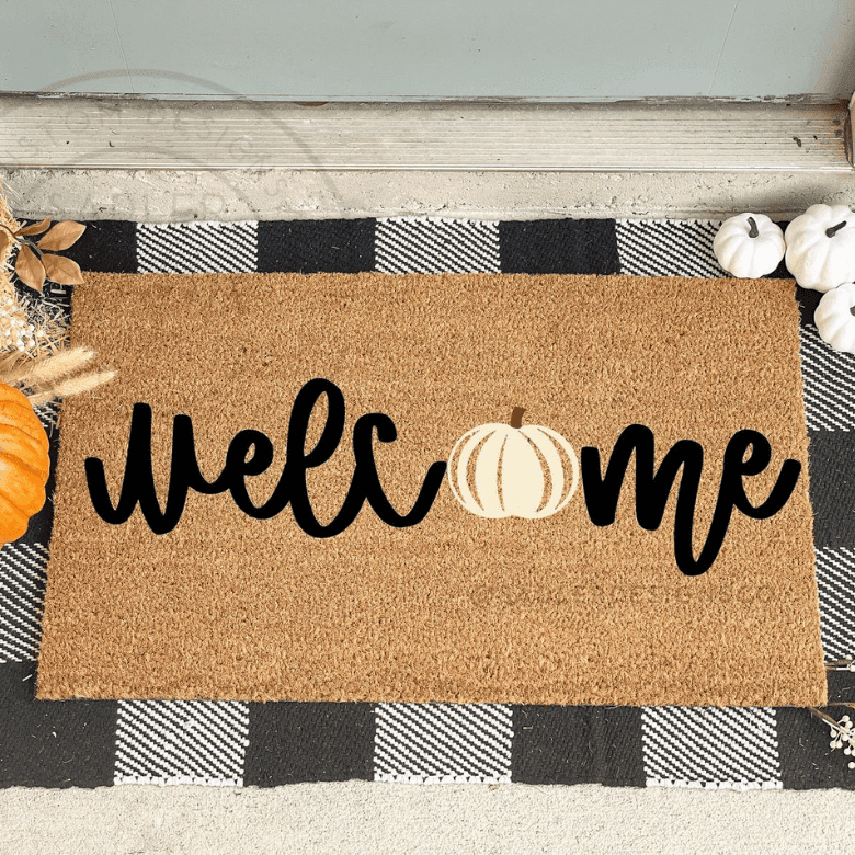 Fall-themed doormat with "Welcome" text, featuring a pumpkin design in place of the letter O