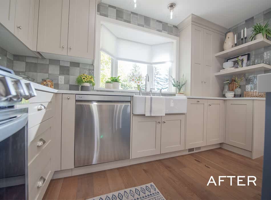Renovated kitchen with beige cabinets, farmhouse sink, stainless steel dishwasher, and wood flooring