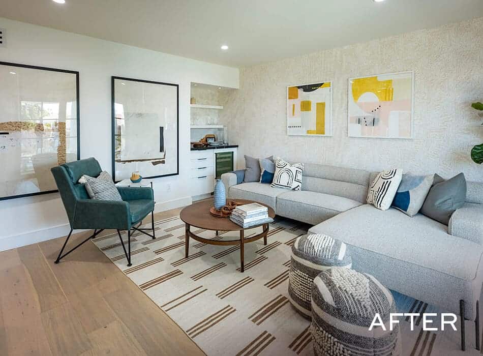 Living room with a sectional sofa, green armchair, abstract artwork, and a built-in bar area