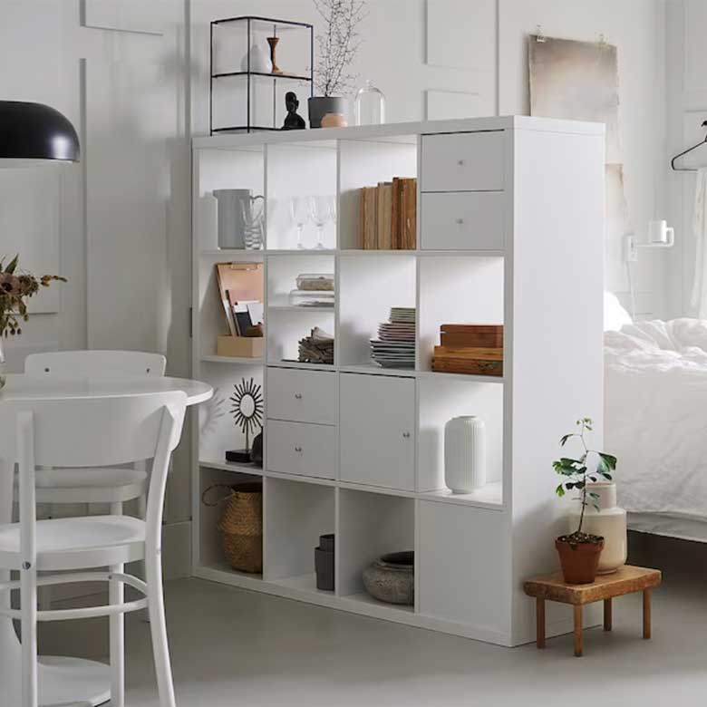 White cube shelf serves as storage and a room divider