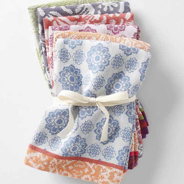 Stack of colorful patterned textiles tied with a ribbon