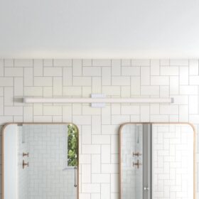 Modern bathroom with long LED vanity light, two arched mirrors, and white geometric tile wall