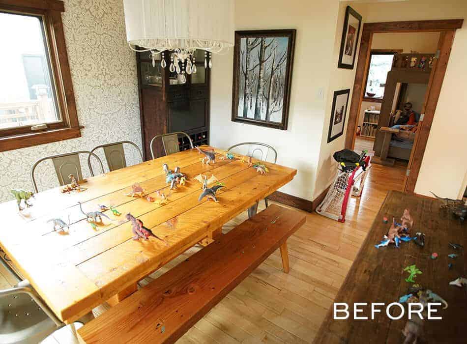 Dining room with wooden table, metal chairs, toy dinosaurs, wall art, and light wood flooring