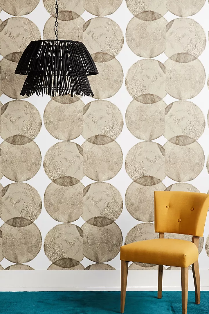 Contemporary interior with a light teal rug on the floor and a mustard yellow chair