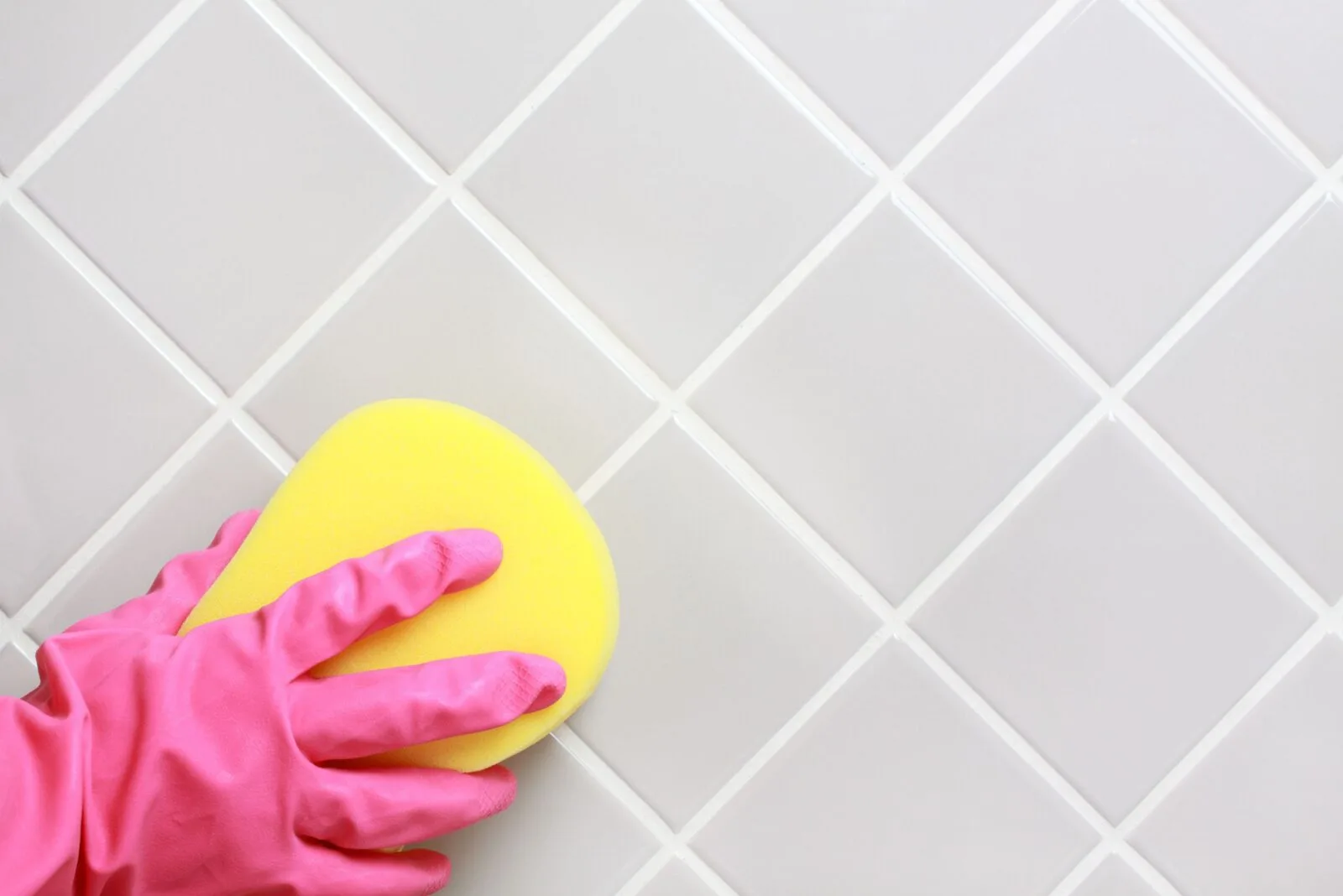 cleaning tile with a sponge