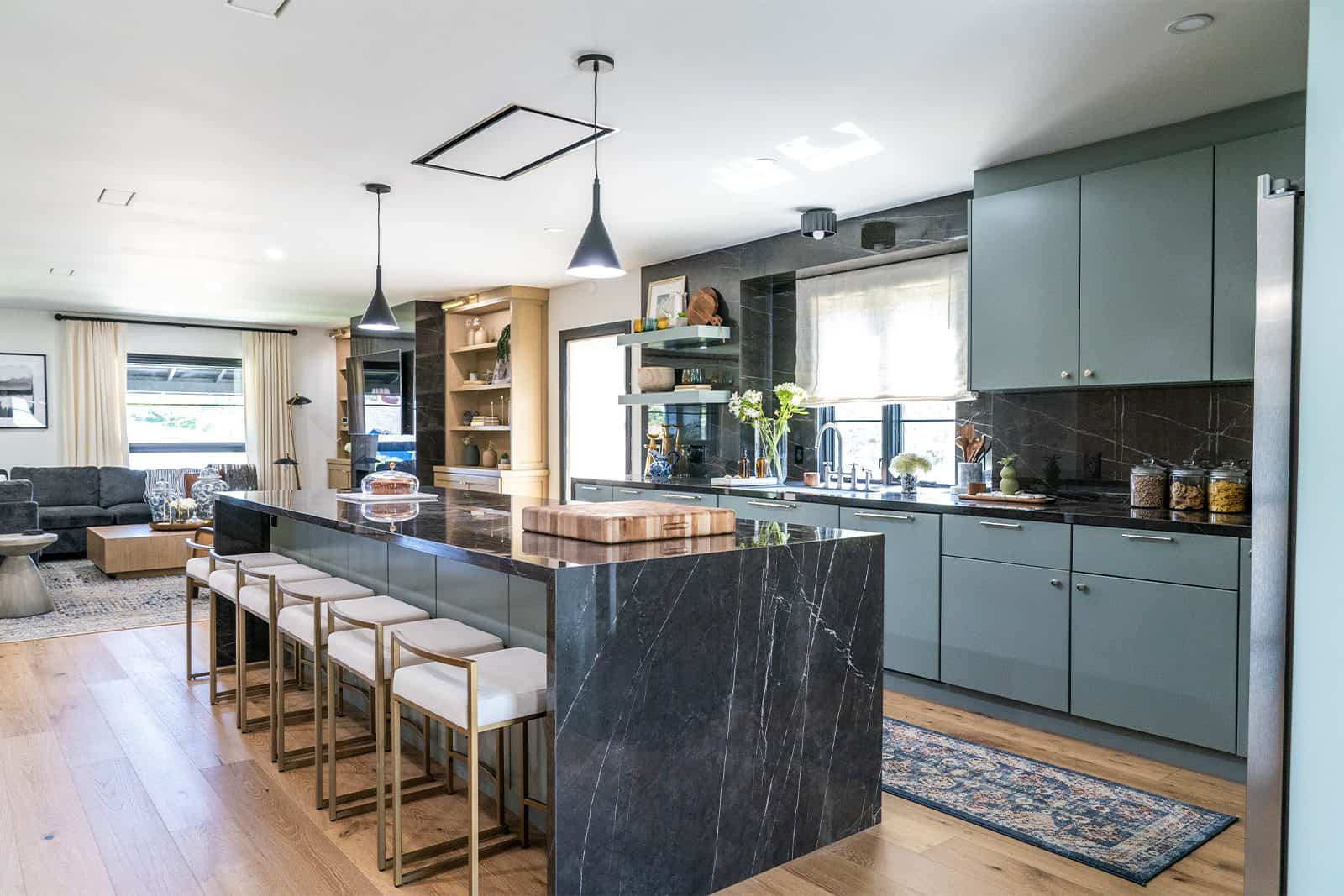 brother vs brother team jonathan marble waterfall island with modern stools and blue cabinets