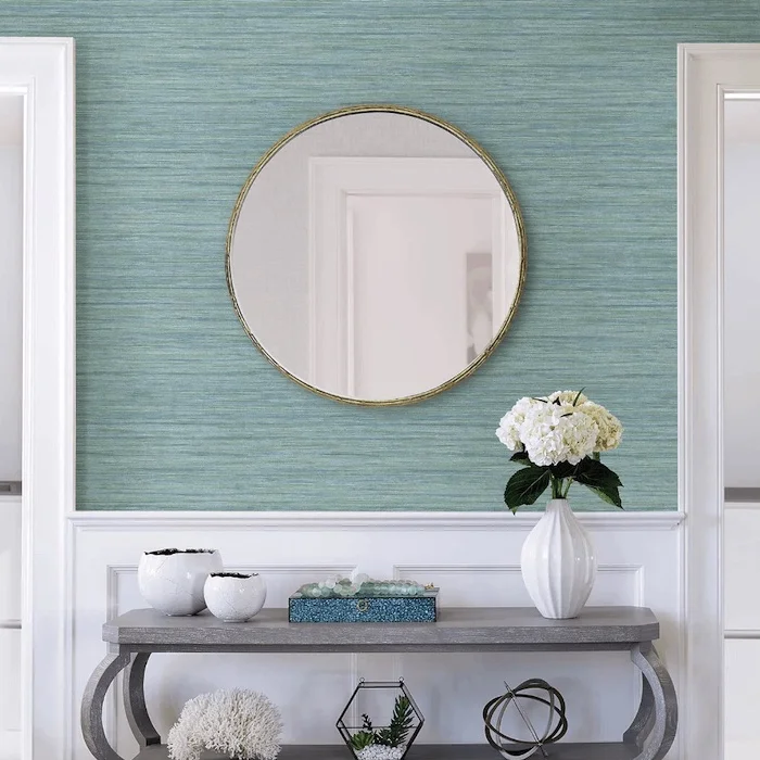 living room with light blue wallpaper and white accents