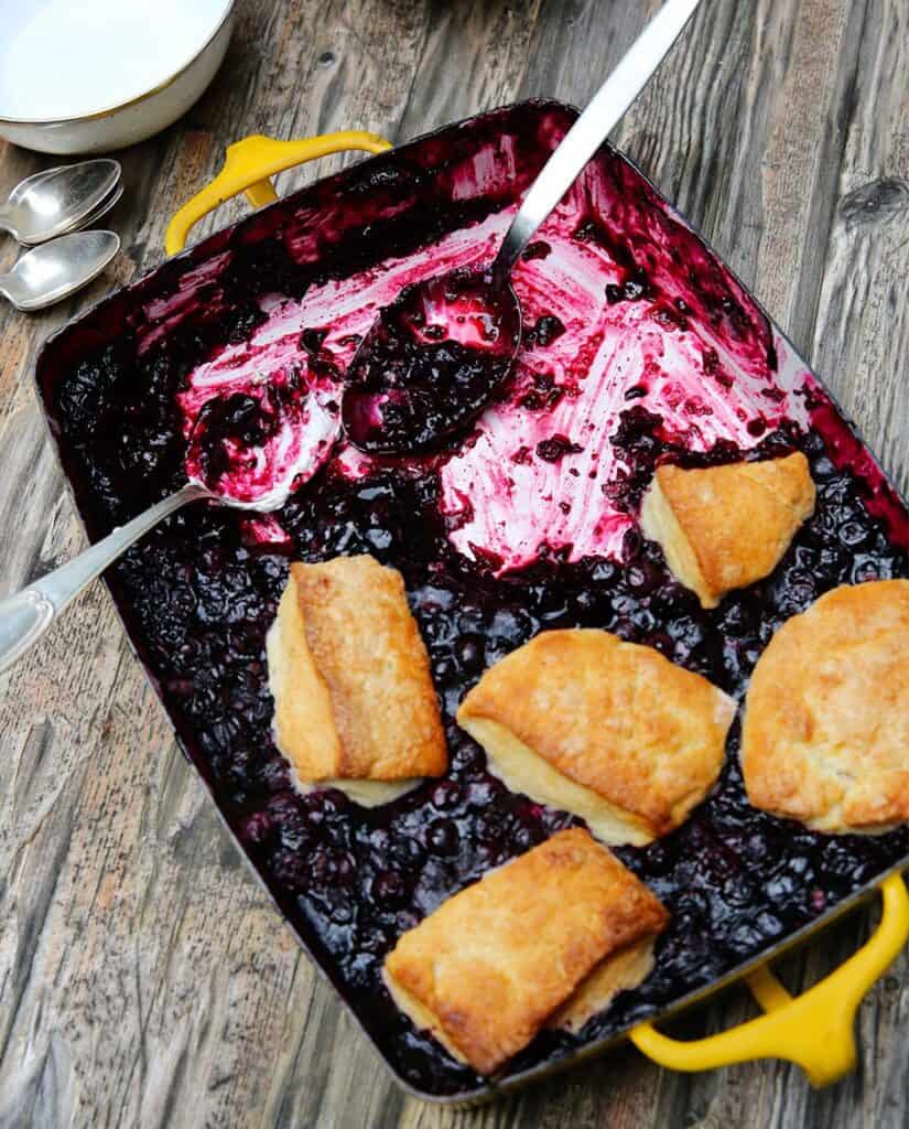 Blueberry cobbler in yellow baking dish