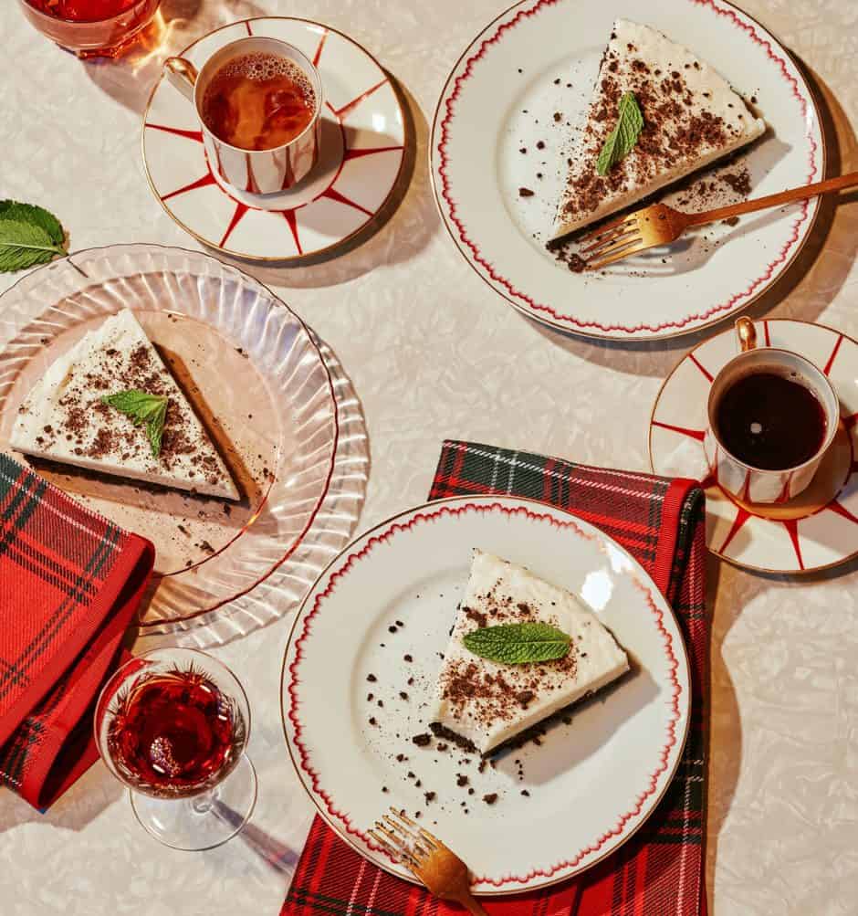 Three slices of mint pie on plates with one that has a bite taken