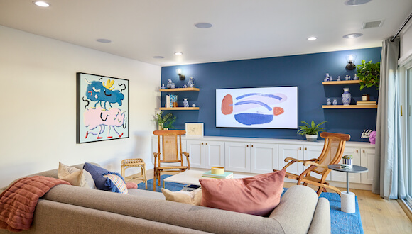 Blue accent wall with colorful wall art