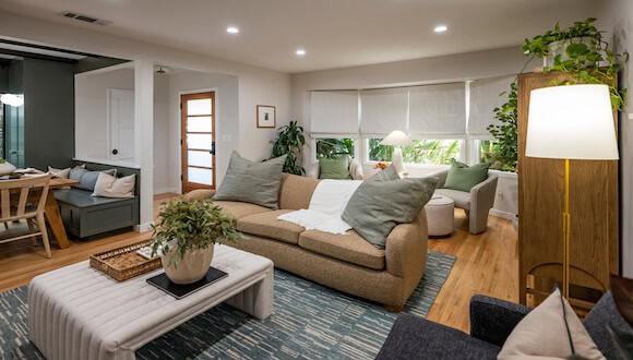 Brown living room couch with gray pillows